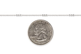 Sterling silver chain next to a U.S. quarter dollar coin for scale on a white background
